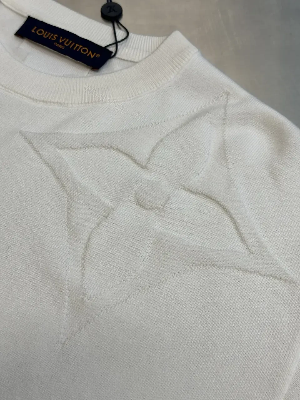 View 4 of Off-White Cream Oversized Tee with Embossed Logo Pattern