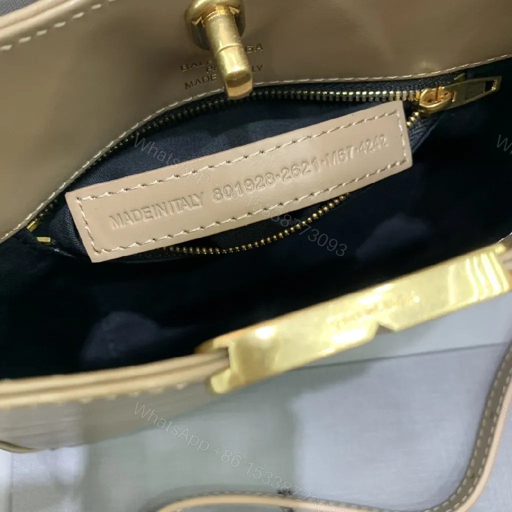 View 6 of Compact Taupe Leather Handbag with Gold Hardware, Crossbody Ready
