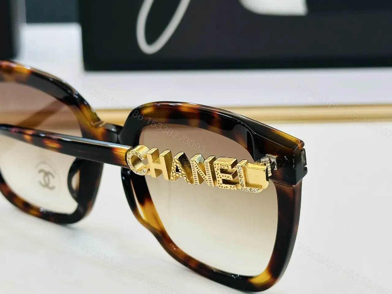 View 4 of Bold Black Frame Sunglasses with Gold Detailing