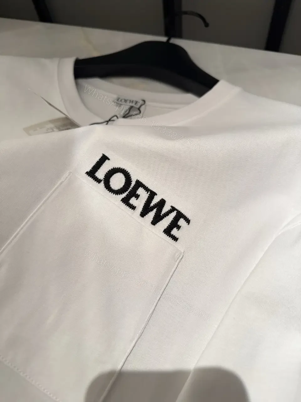 View 8 of Minimalist White Tee with Structured Pocket & Logo Emblem