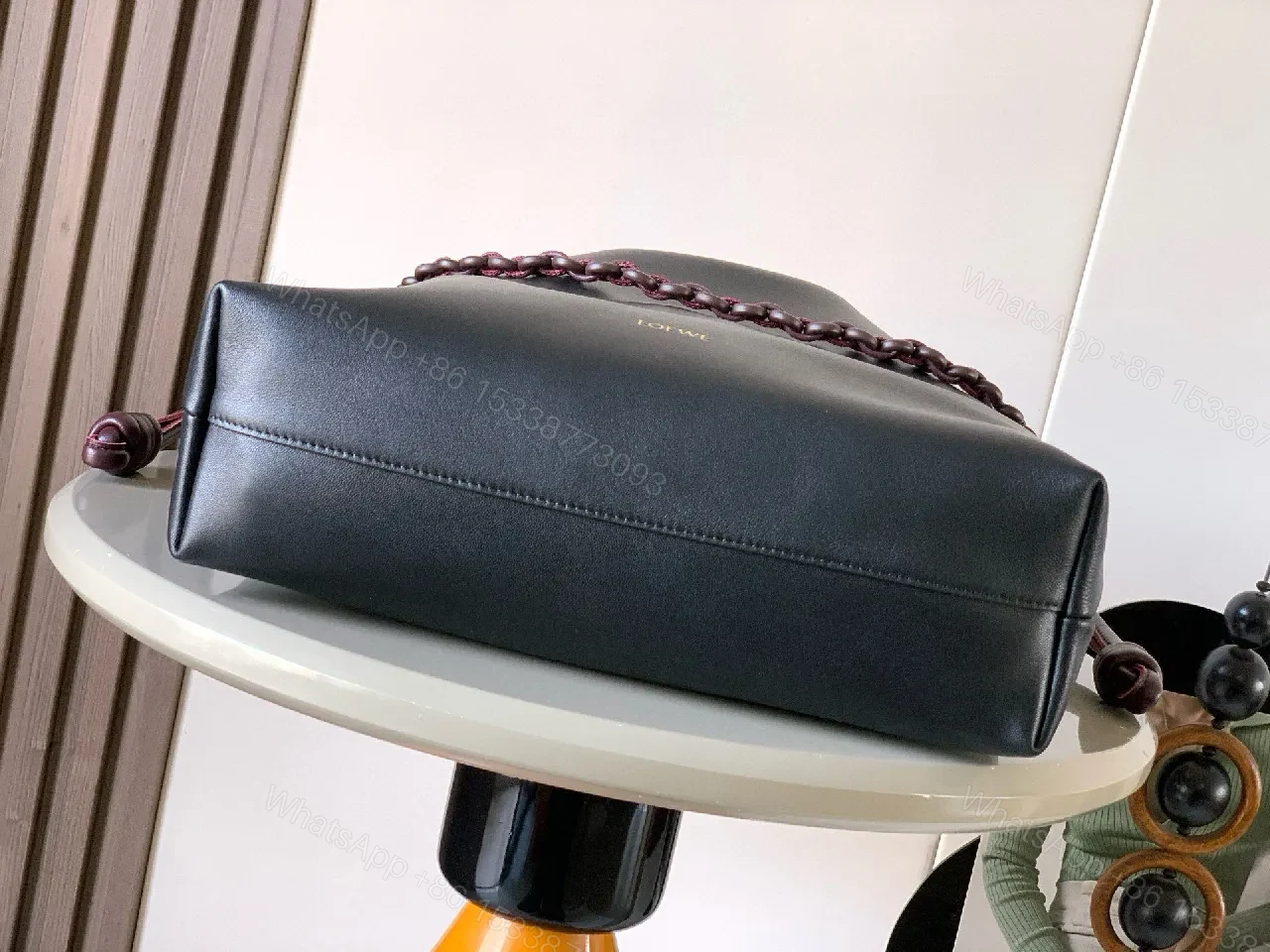 View 8 of Two-Tone Leather Drawstring Bucket Bag with Chain Detail