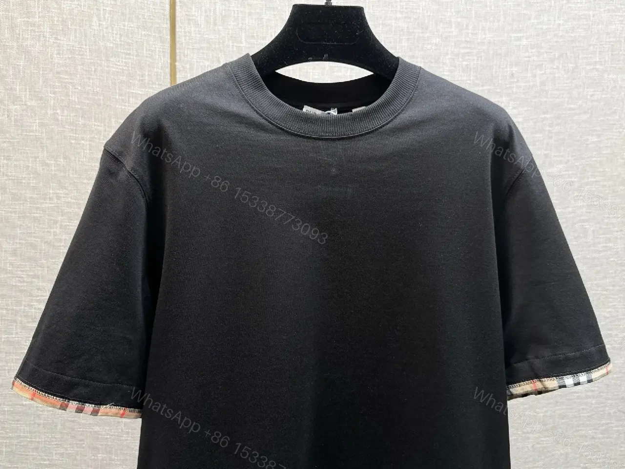 View 2 of Minimalist Black Cotton Tee with Plaid Sleeve Trim