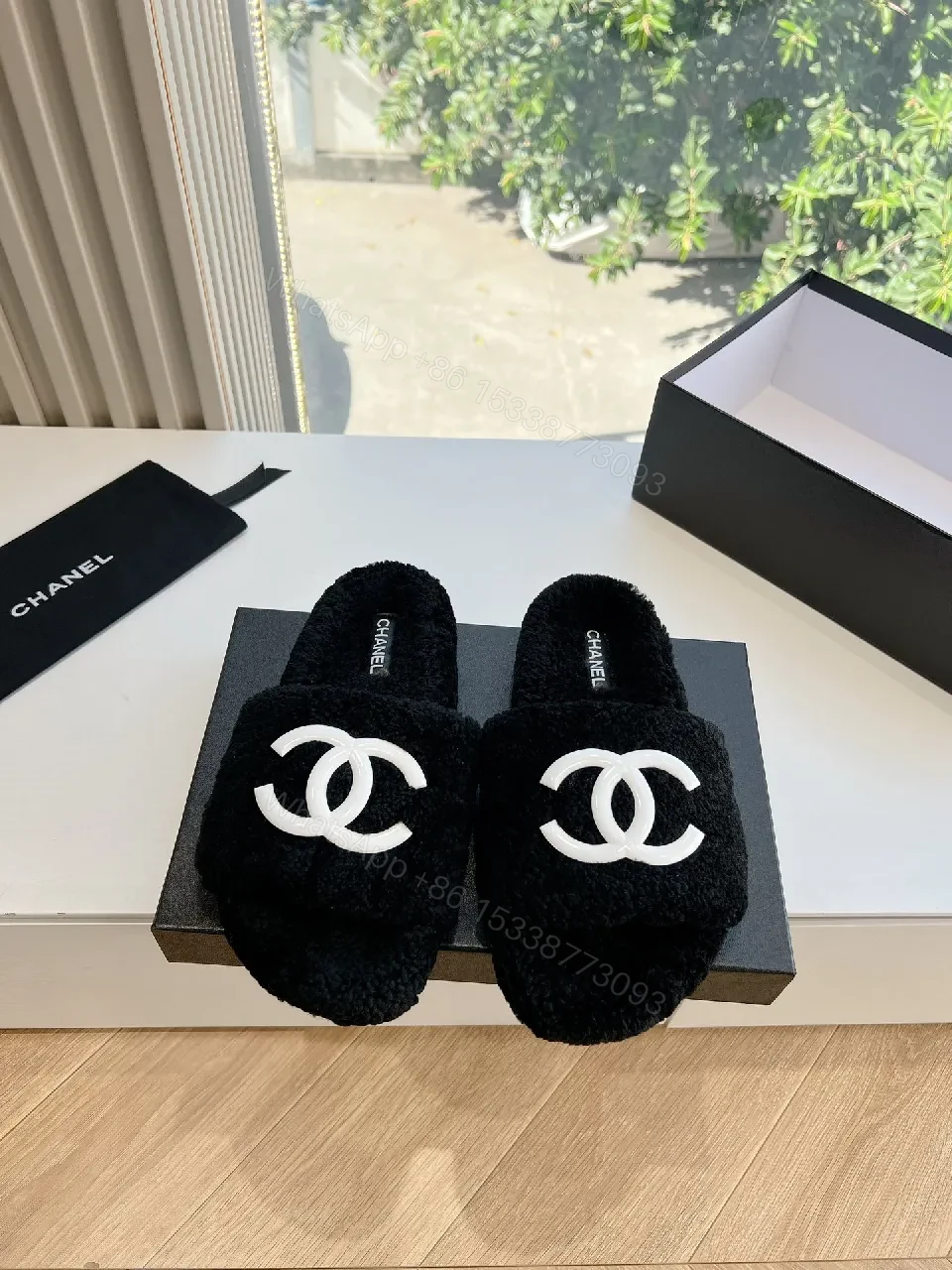 View 3 of Cozy Black Plush Slippers with Logo Detail