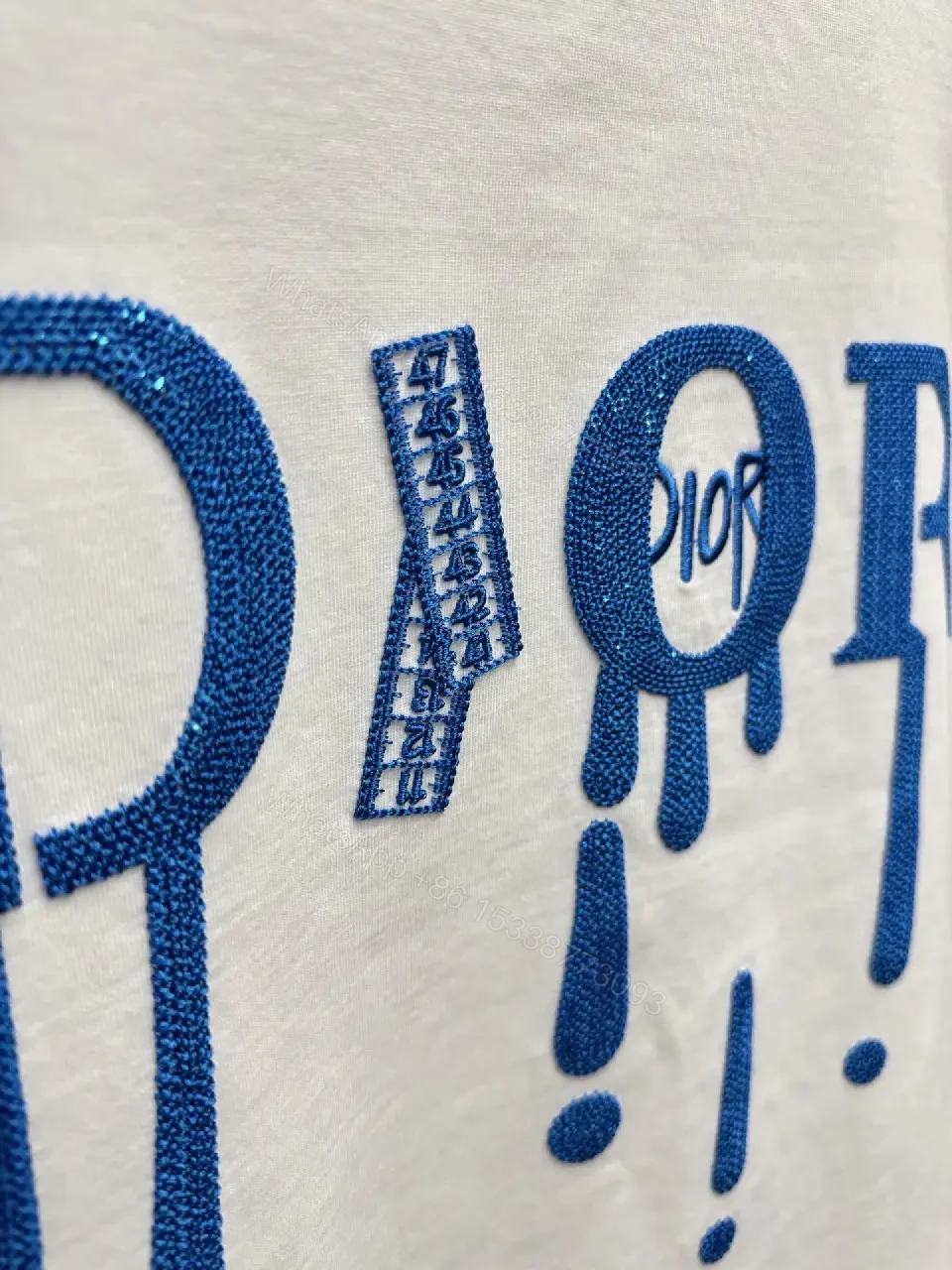 View 2 of Minimalist White Tee with Blue Embroidered Logo, Premium Cotton