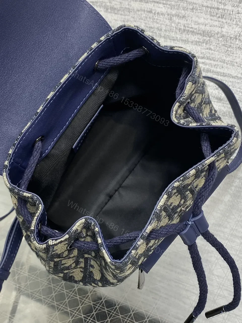 View 2 of Navy Canvas Monogram Compact Backpack with Leather Accents