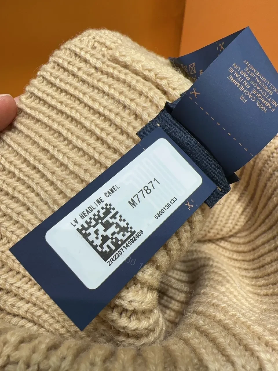 View 2 of Textured Camel Knit Beanie with Gold Crest - Cozy Luxury Style