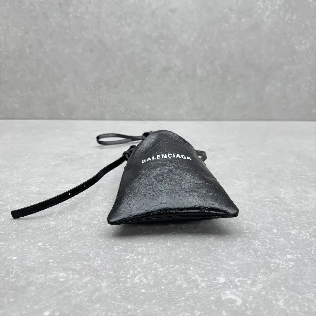 View 9 of Black Leather Drawstring Crossbody Bag - Minimalist Luxe Compact Carry