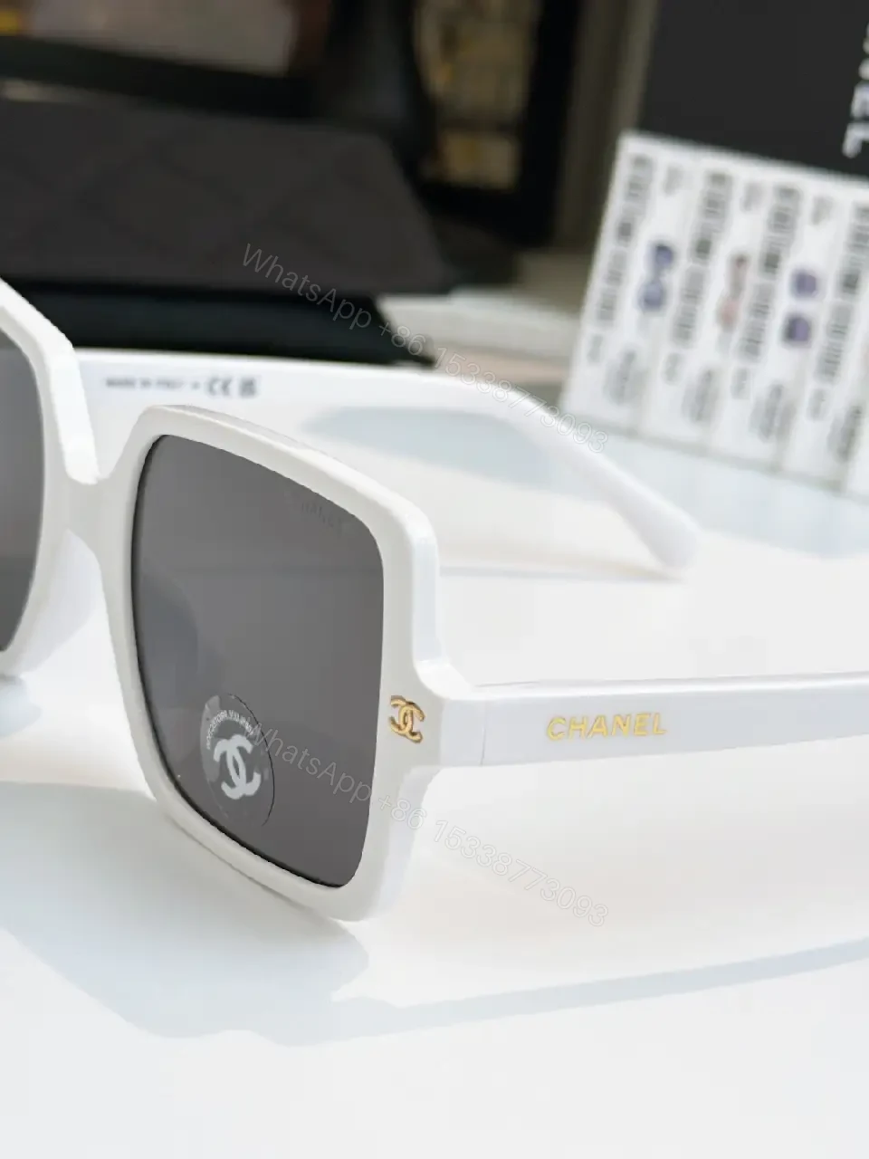 View 7 of Black Frame Oversized Sunglasses with Gold Chanel Logos, Matte Gray Lenses