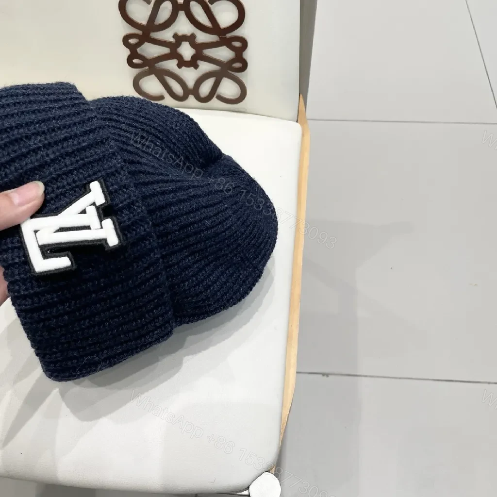 View 3 of Cozy Black Knit Beanie with Subtle Emblem Detail
