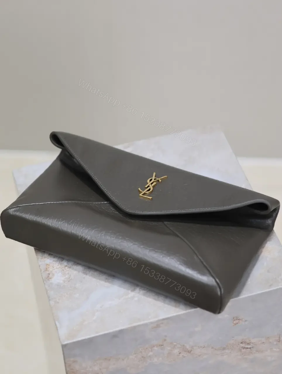 View 5 of Textured Black Leather Envelope Clutch with Gold Logo Signature