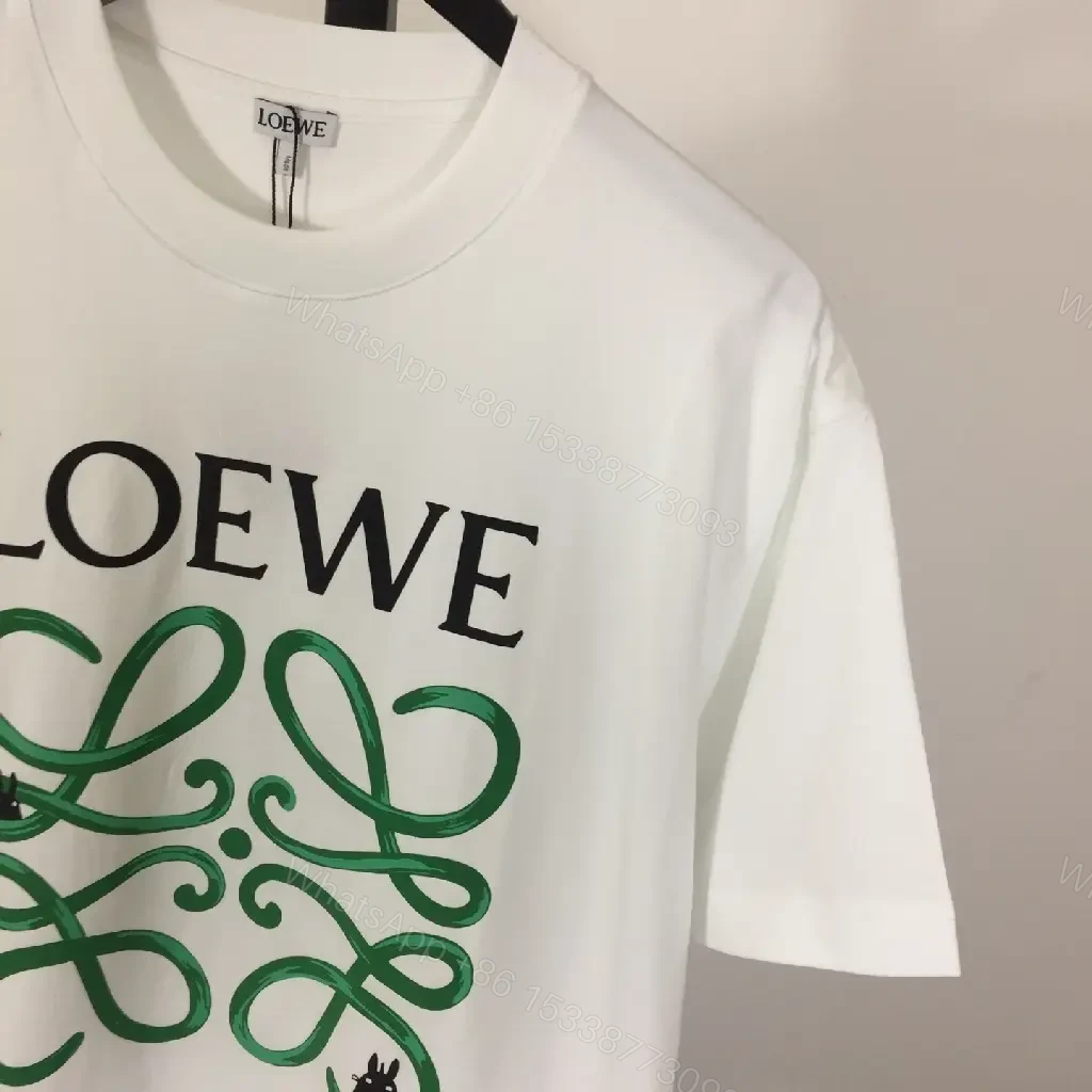 View 3 of White Cotton Graphic Tee – Opulent Comfort, Bold Logo, Casual Luxury