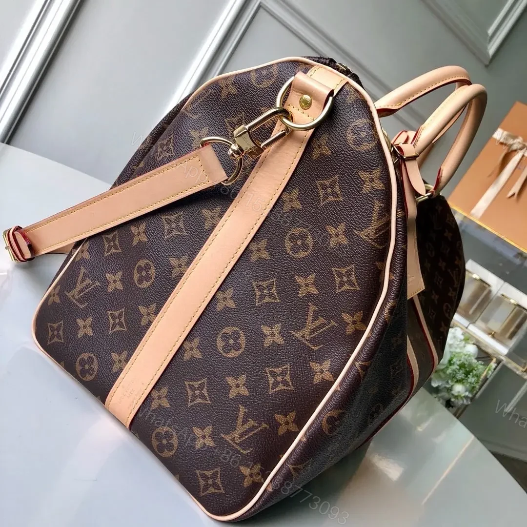 View 7 of LV Monogram Canvas Keepall Bandoulière 55 Leather Duffle Bag