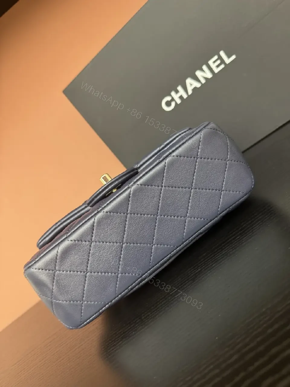 View 7 of Quilted Leather Mini Bag with Gold Emblem - Compact Glamour