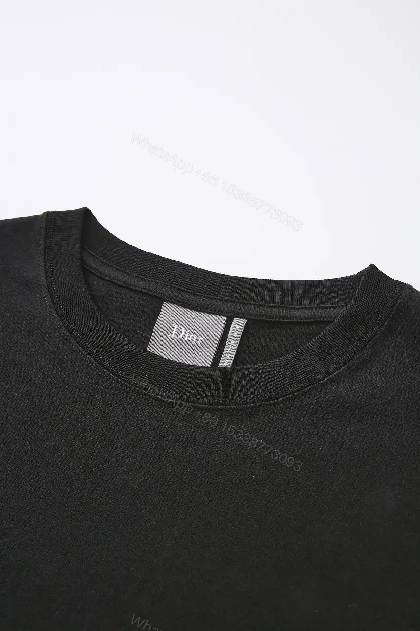 View 5 of Minimalist Black Cotton Tee with Subtle Embossed Logo - T‐Shirt