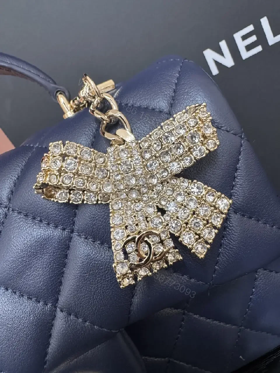 View 2 of Quilted Leather Mini Bag with Gold Emblem - Compact Glamour