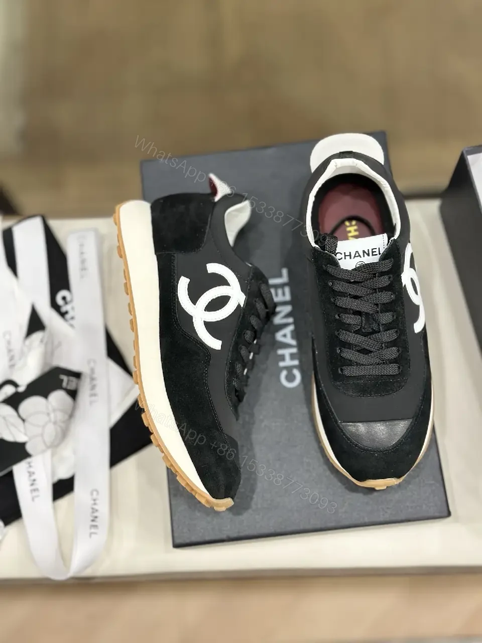 View 4 of Sleek Black Knit High-Top Sneaker with Signature Emblem, Luxury