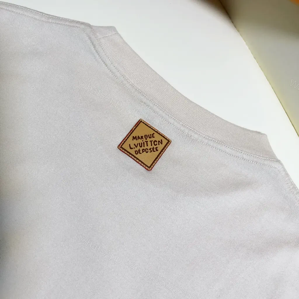 View 3 of White Cotton Minimal T-Shirt with LV.M Logo