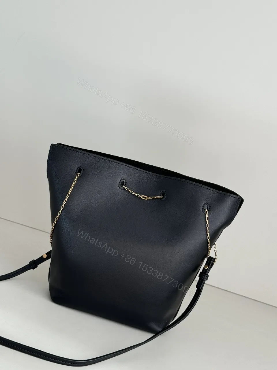 View 7 of Chic Black Leather Bucket Bag with Gold Logo