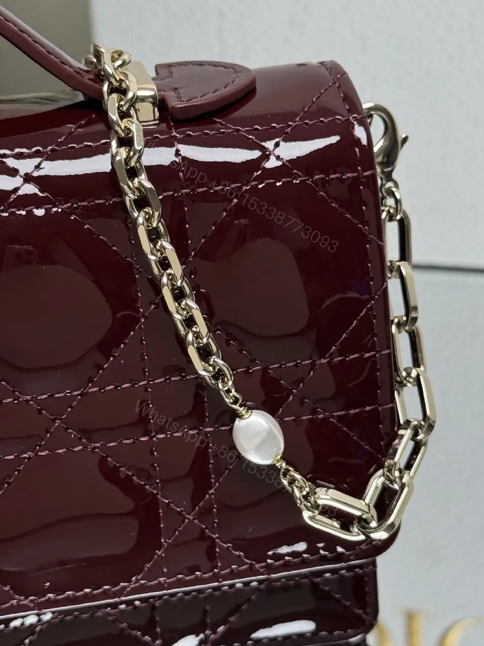 View 4 of Burgundy Patent Leather Clutch: Geometric Quilted Luxury