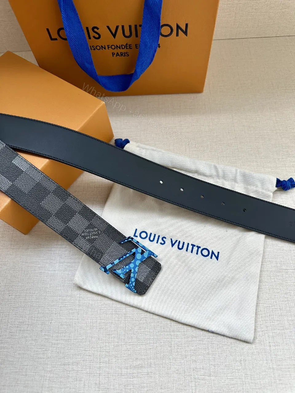 View 2 of Bold Checker Belt with Blue Buckle — Modern Luxury Accessory