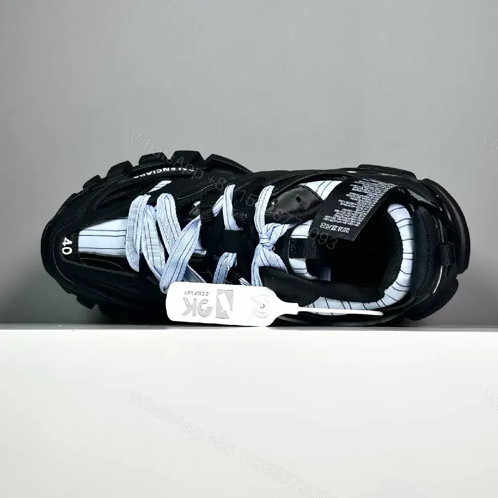 View 4 of black leather and mesh sneakers with logo motif for luxury streetwear