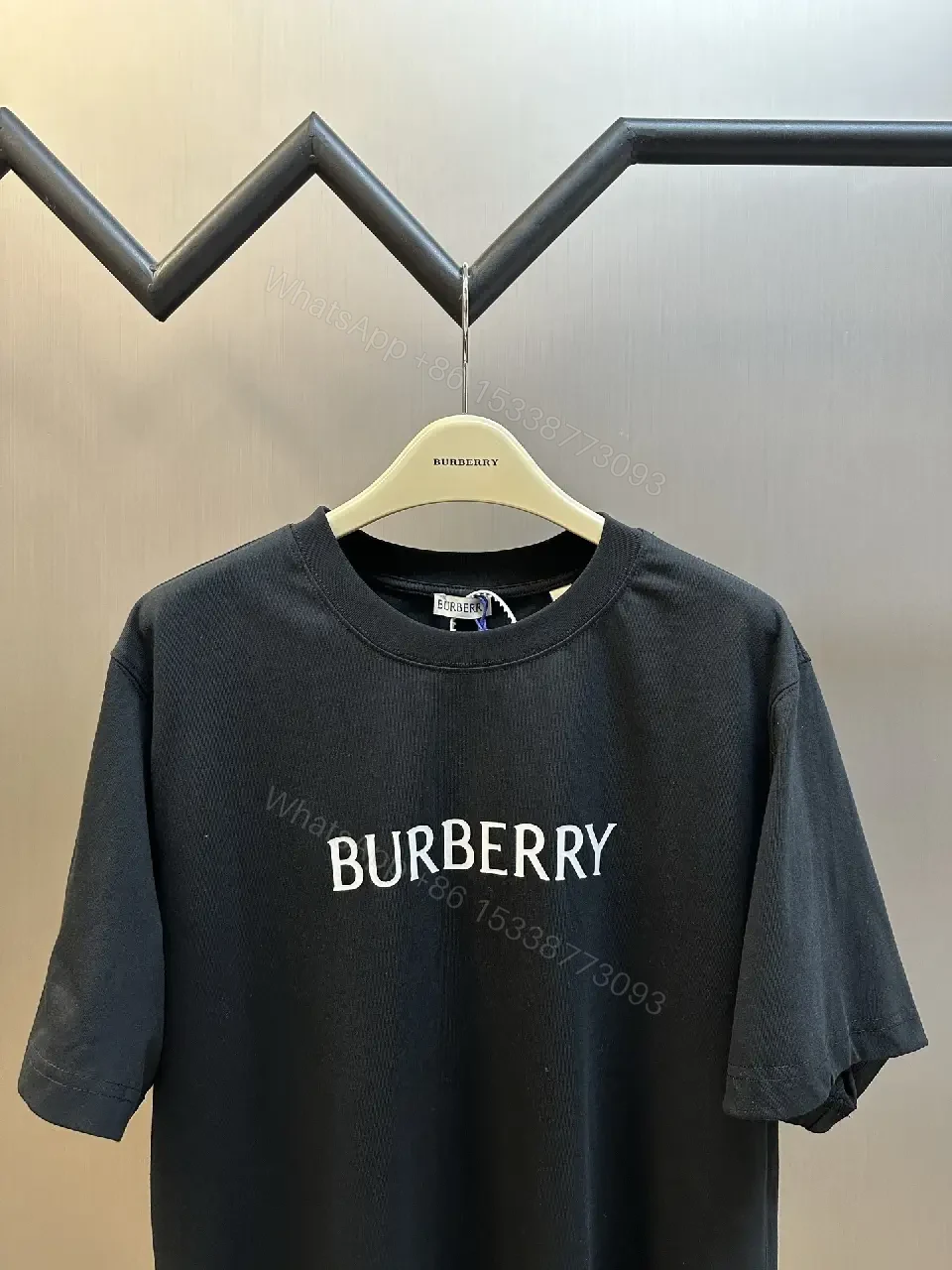 View 4 of Minimalist Black Cotton Tee | Relaxed Fit, Logo Accent, Everyday Luxury