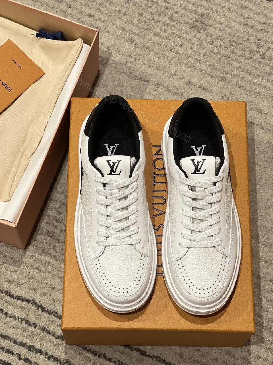 View 2 of Minimalist White Leather Sneakers with Signature Detail - Modern Luxury