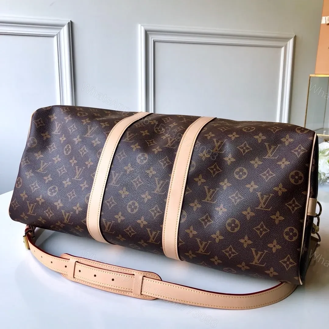 View 2 of LV Monogram Canvas Keepall Bandoulière 55 Leather Duffle Bag