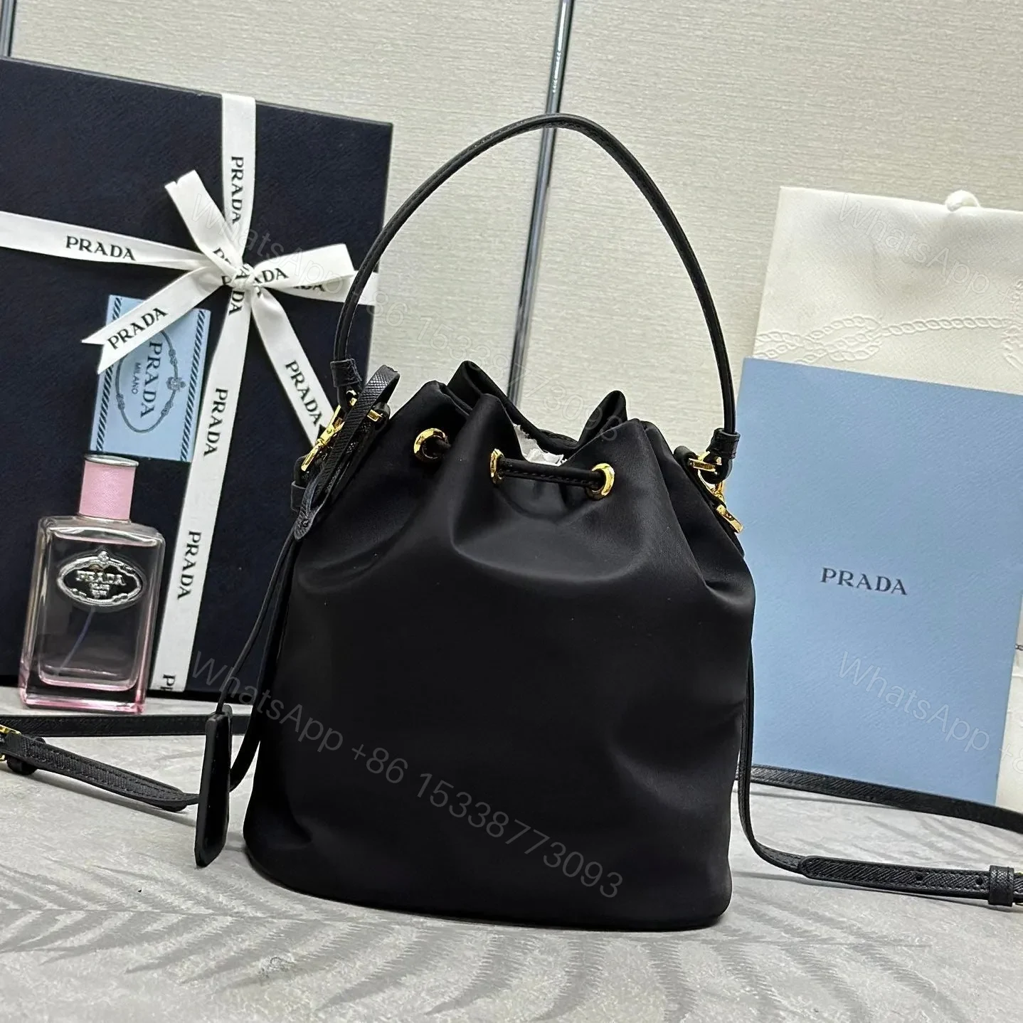 View 2 of BUCKET BAG 19 IN BLACK RE-NYLON AND CALFSKIN HANDLE