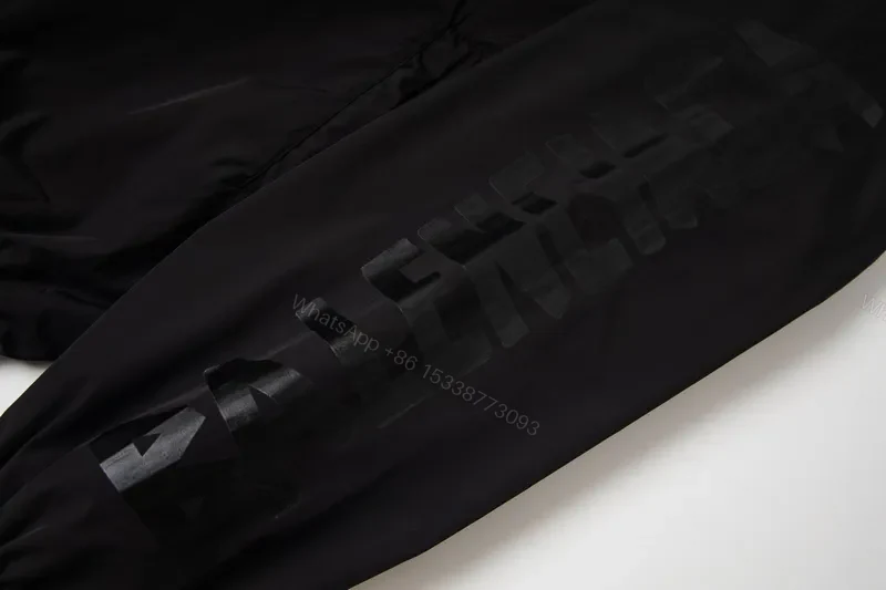 View 10 of Minimalist Black Windbreaker: Subtle Branding, All-Season Outerwear