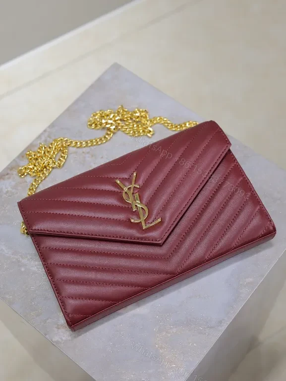 View 2 of Burgundy Quilted Envelope Crossbody Bag with Gold YSL Logo