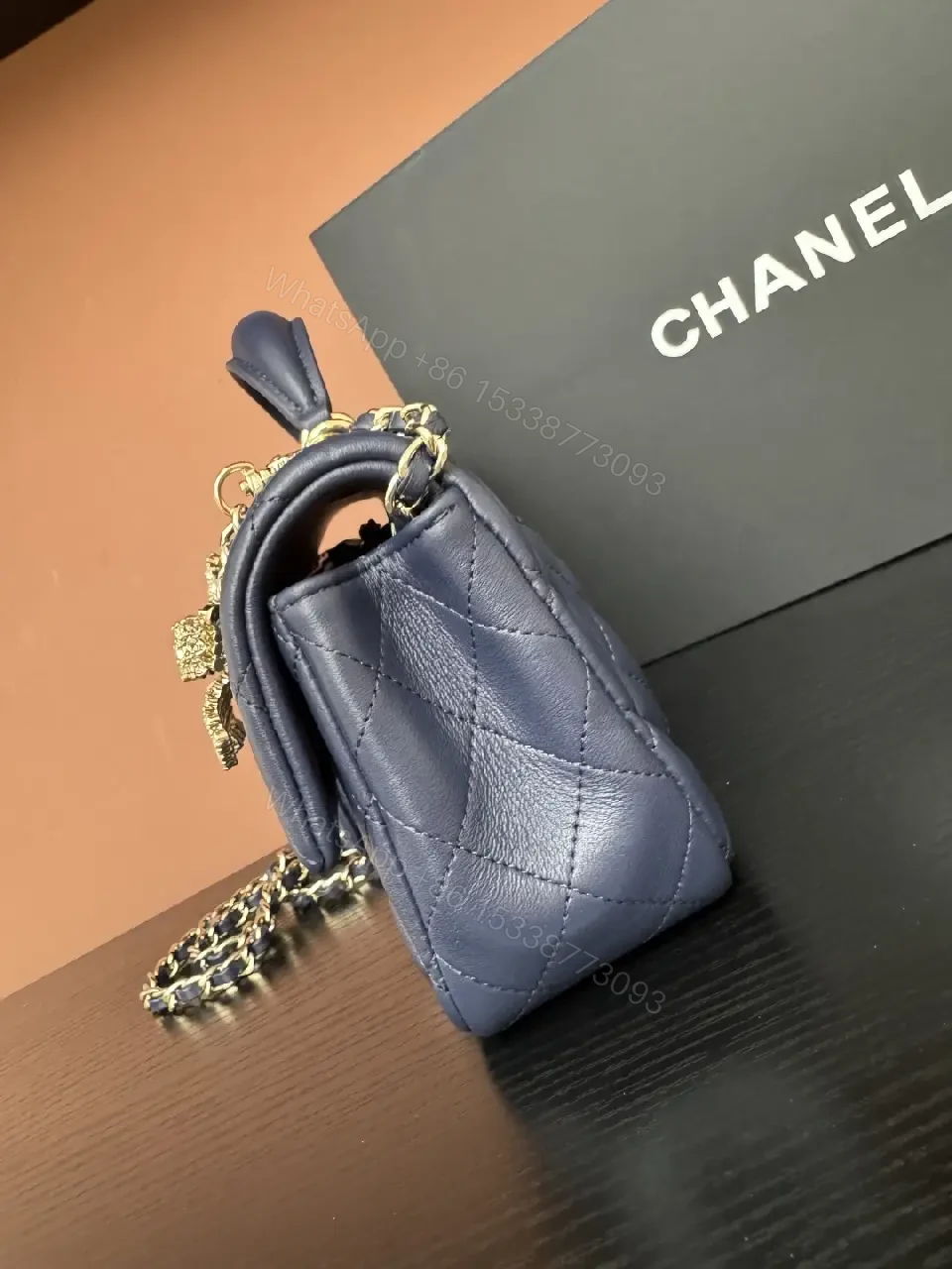 View 8 of Quilted Leather Mini Bag with Gold Emblem - Compact Glamour