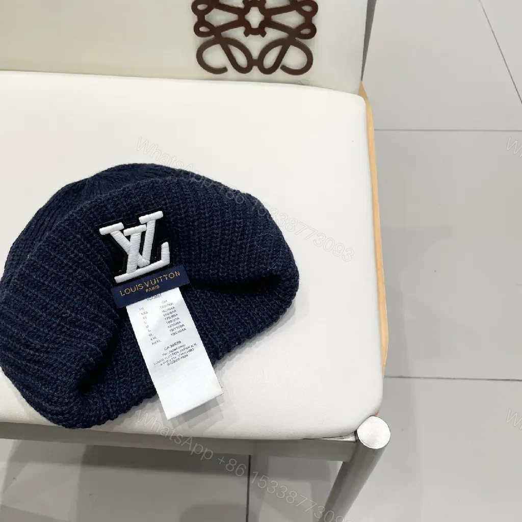 View 8 of Cozy Black Knit Beanie with Subtle Emblem Detail