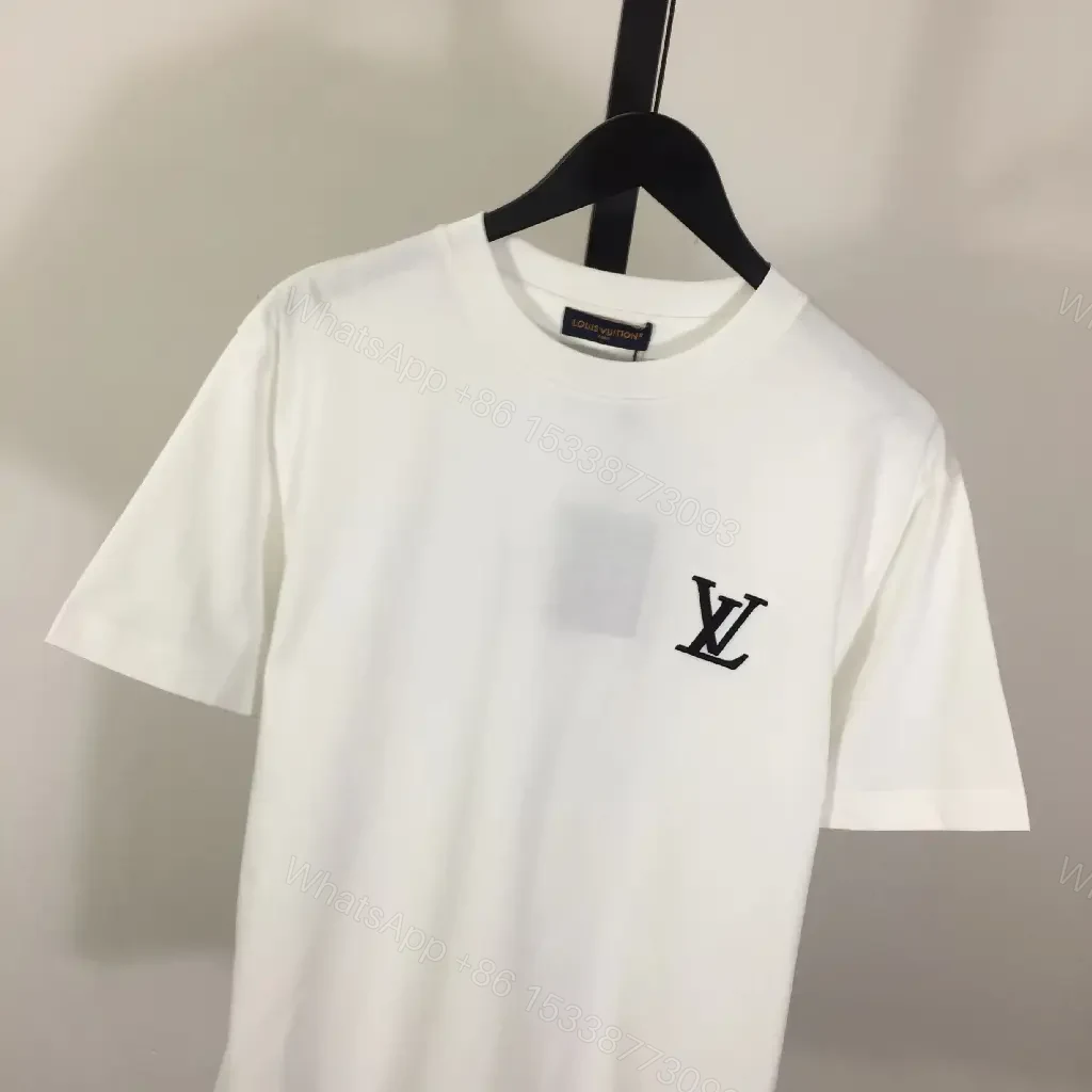 View 7 of Classic White Tee - Premium Cotton, Subtle Emblem, Everyday Luxe