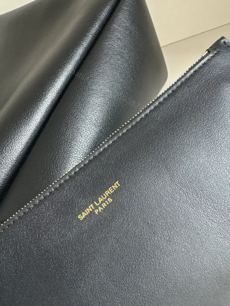 View 4 of Navy Leather Bucket Bag with Gold YSL Charm and Zippered Pocket