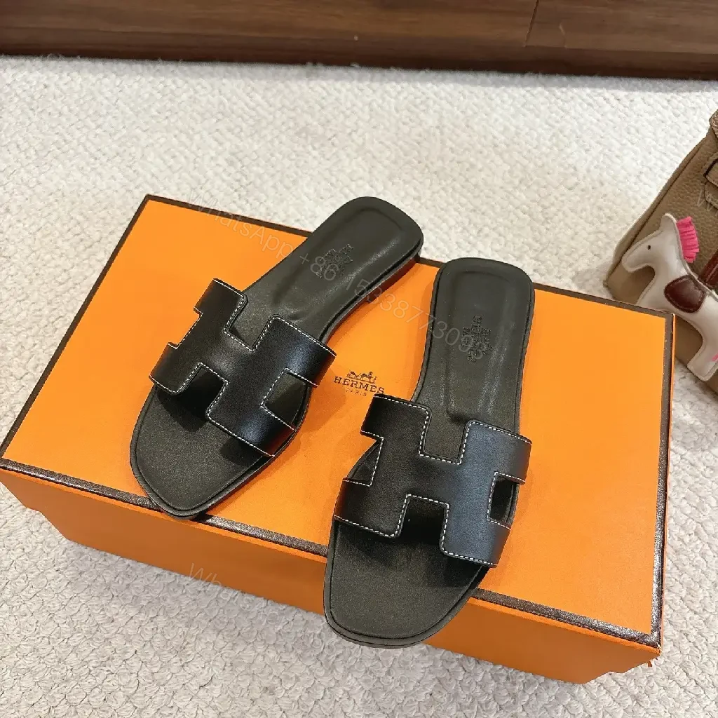 View 5 of black leather slide sandals with H-shaped buckles for luxury everyday