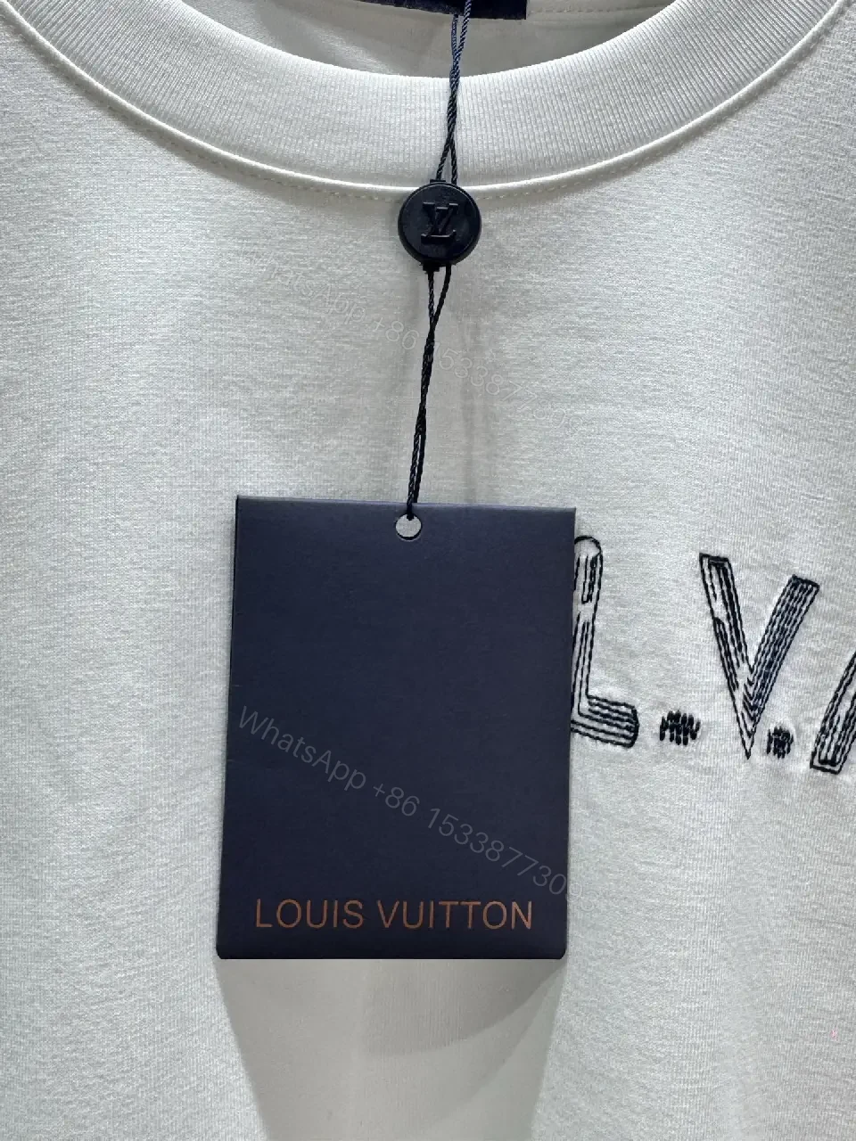 View 8 of Minimalist White Tee with Subtle L.V.M. Logo—Premium Everyday Essential