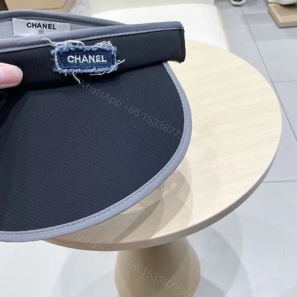 View 2 of Minimalist Black Visor with Chanel-Inspired Detail, UV Shield