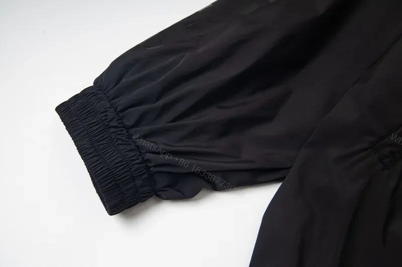 View 5 of Minimalist Black Windbreaker: Subtle Branding, All-Season Outerwear