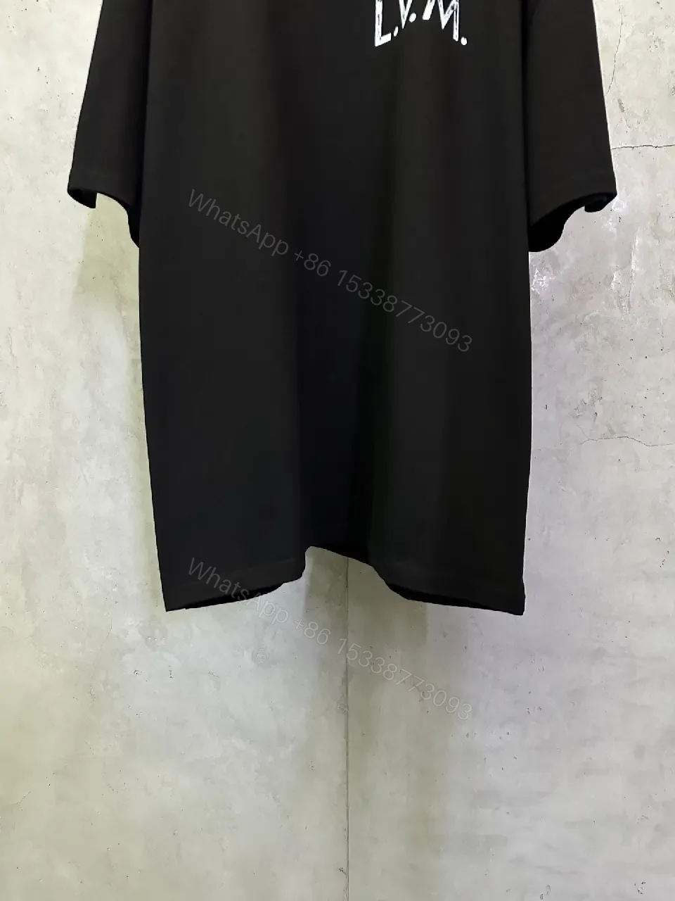 View 5 of Minimalist Black Tee with Subtle LV.M Emblem, Lux Cotton