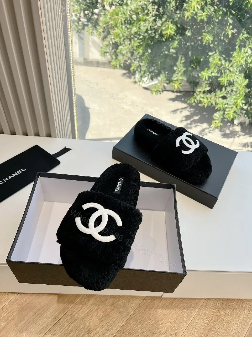 View 2 of Cozy Black Plush Slippers with Logo Detail
