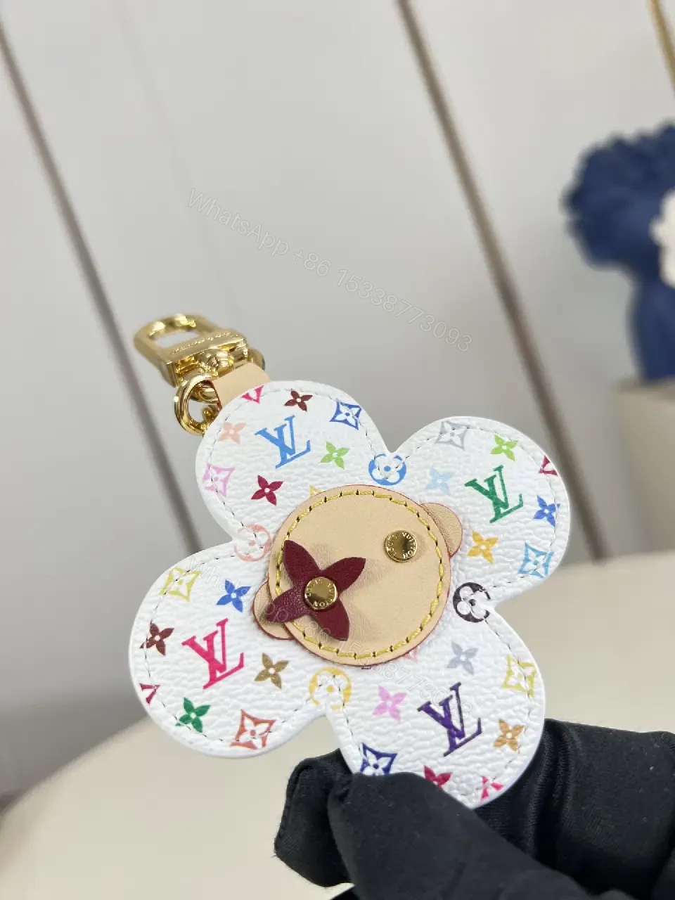 View 6 of White Leather-like Quilted Flower Keychain - LV Monogram Accent, Gold Hardware