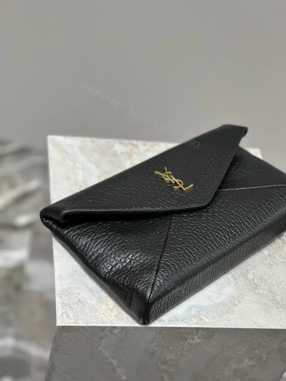 View 3 of Compact Black Leather Envelope Bag with Gold Logo