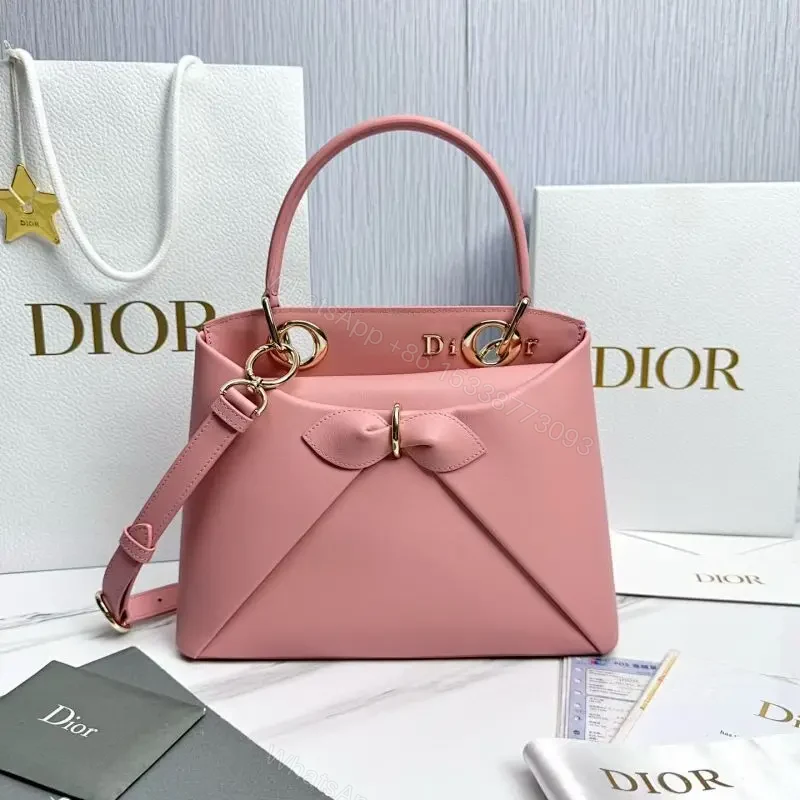 Soft Pink Faux-Leather Satchel: Bow Accent, Sculpted Diagonal Panels, Crossbody Comfort — view 1