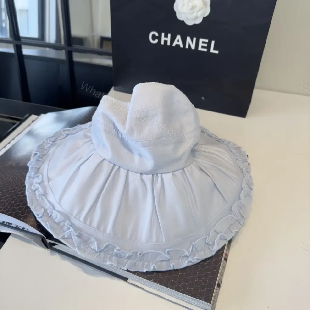View 10 of Pastel Blue Floppy Hat with Ruffled Brim & Chanel Charm