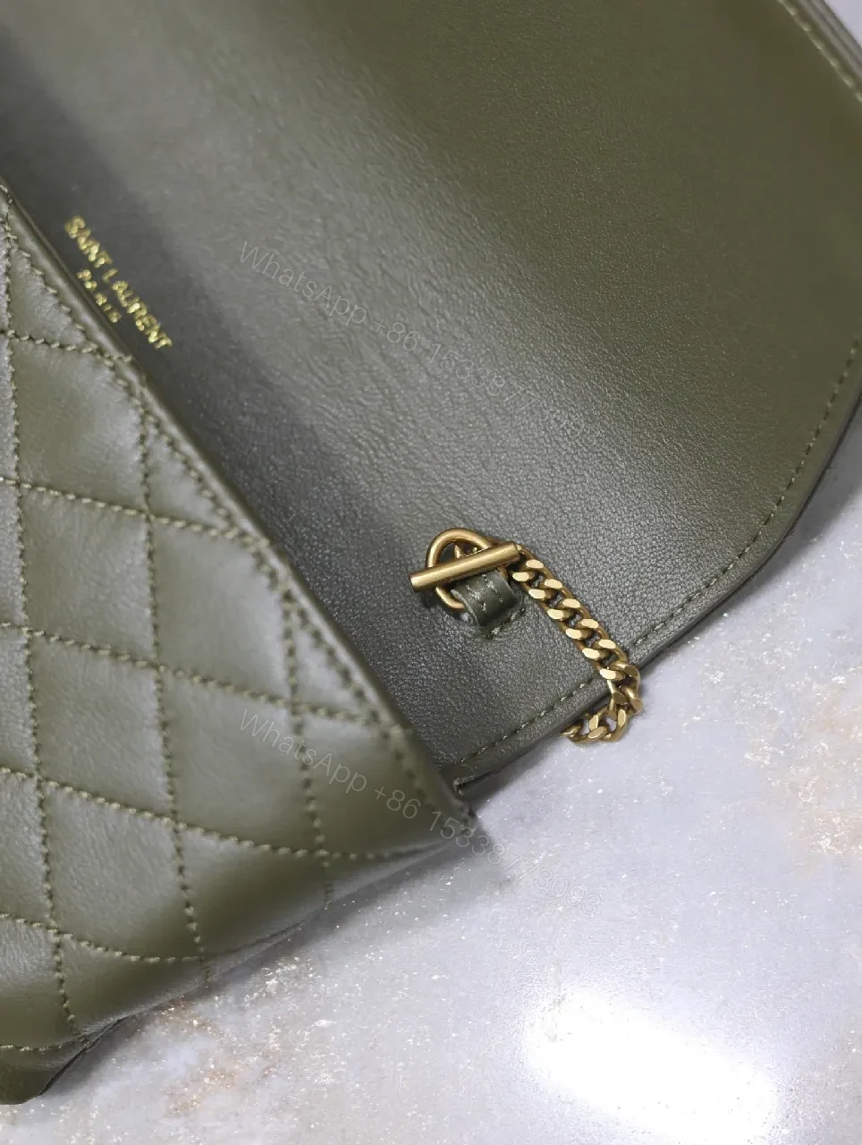 View 6 of Soft-Quilted Leather Clutch with Gold Emblem, Evening Style, Compact Luxury