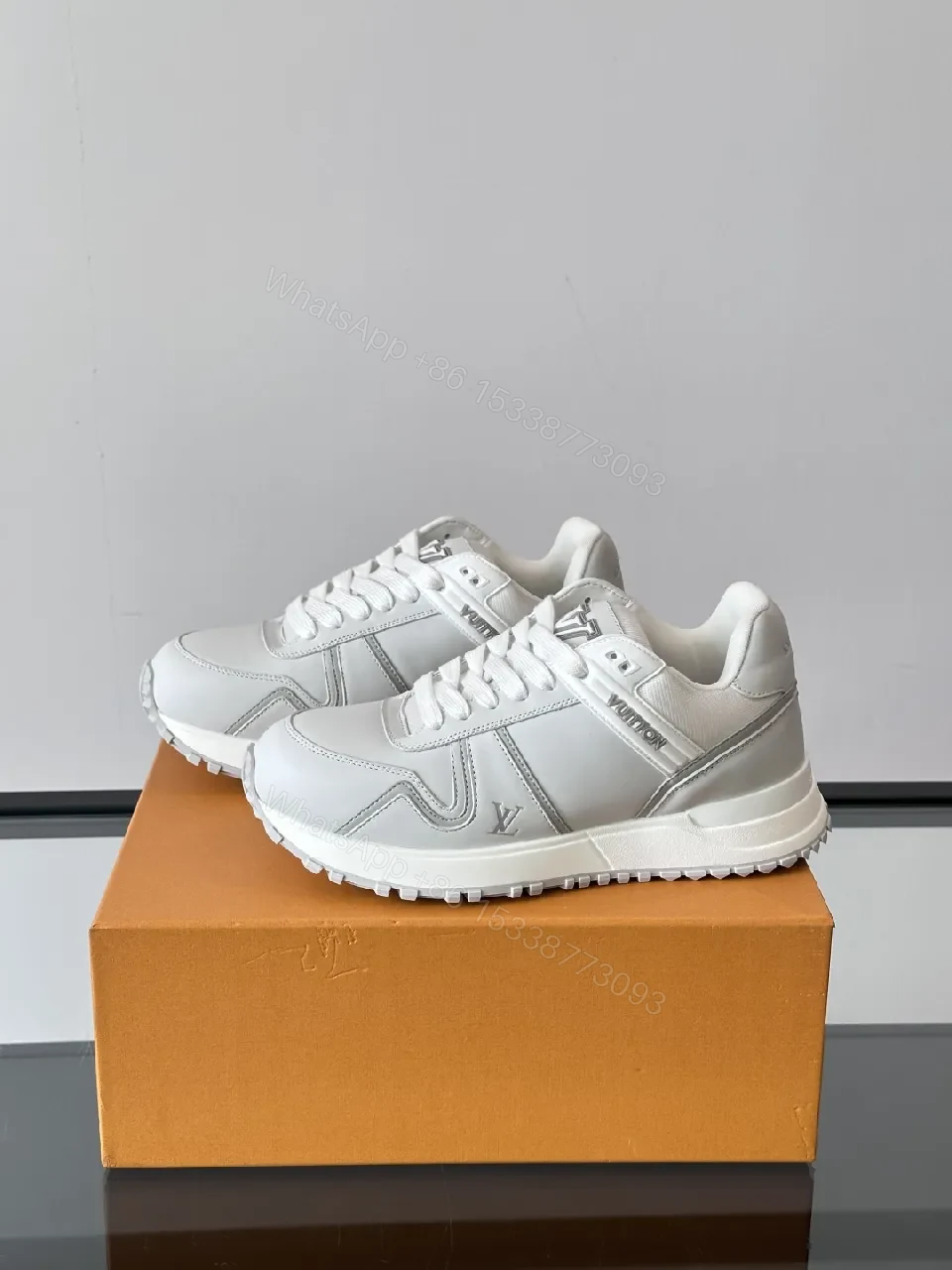 View 5 of Minimalistic White Leather Sneakers with Subtle Texture and Monogram Accent