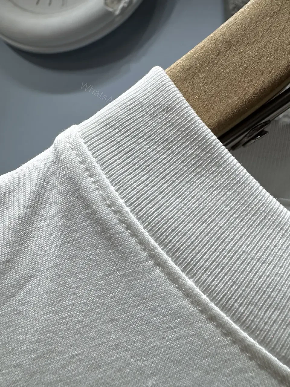 View 4 of Minimalist White T-Shirt with Subtle LV.M Emblem - Premium Cotton