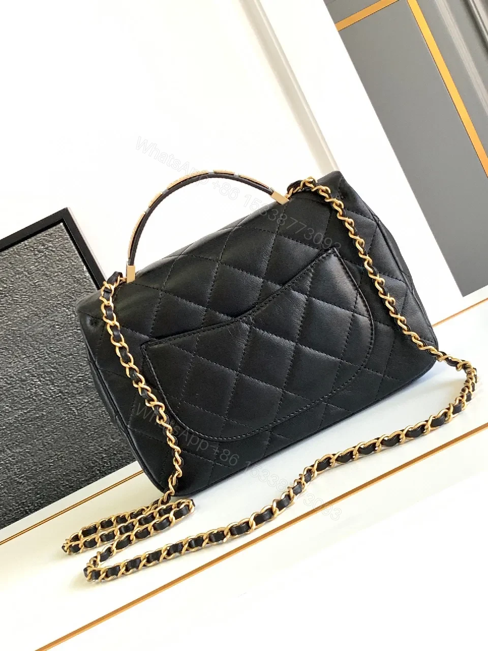 View 2 of Compact Dark Leather Quilted Flap Bag with Gold Hardware