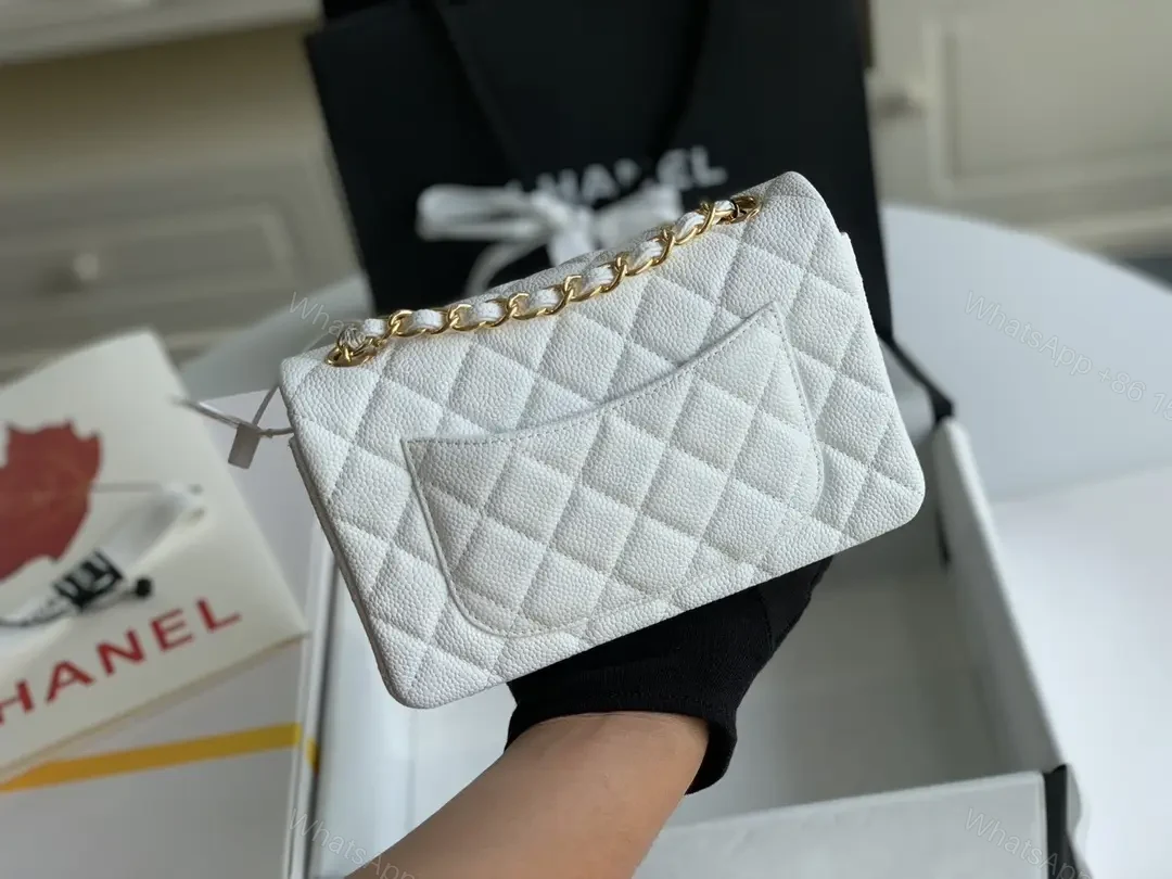 View 5 of Quilted White Flap Bag with Gold Hardware—Compact Elegance
